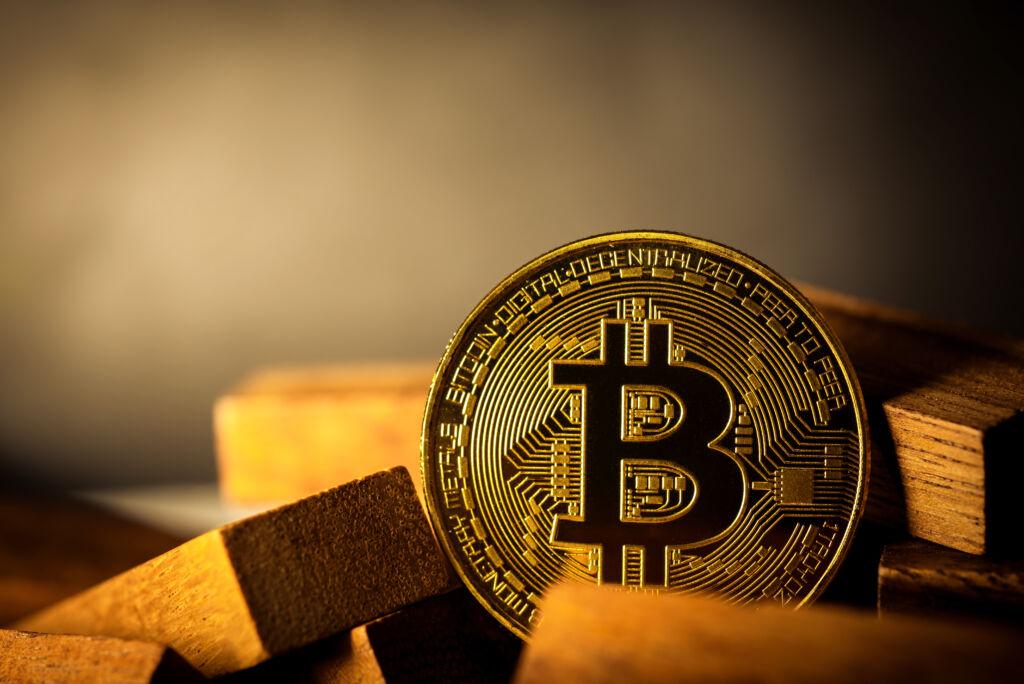 Investičné zlato a Bitcoin vedľa seba – zlaté tehličky a bitcoinová minca ako symbol porovnania tradičného a digitálneho investovania. Ilustračný obrázok.